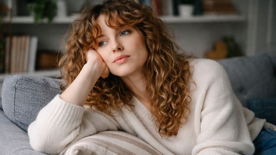 Woman experiencing high functioning depression symptoms at home after maintaining a facade all day