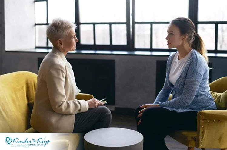 Woman talking with therapist during CBT session to process past trauma.