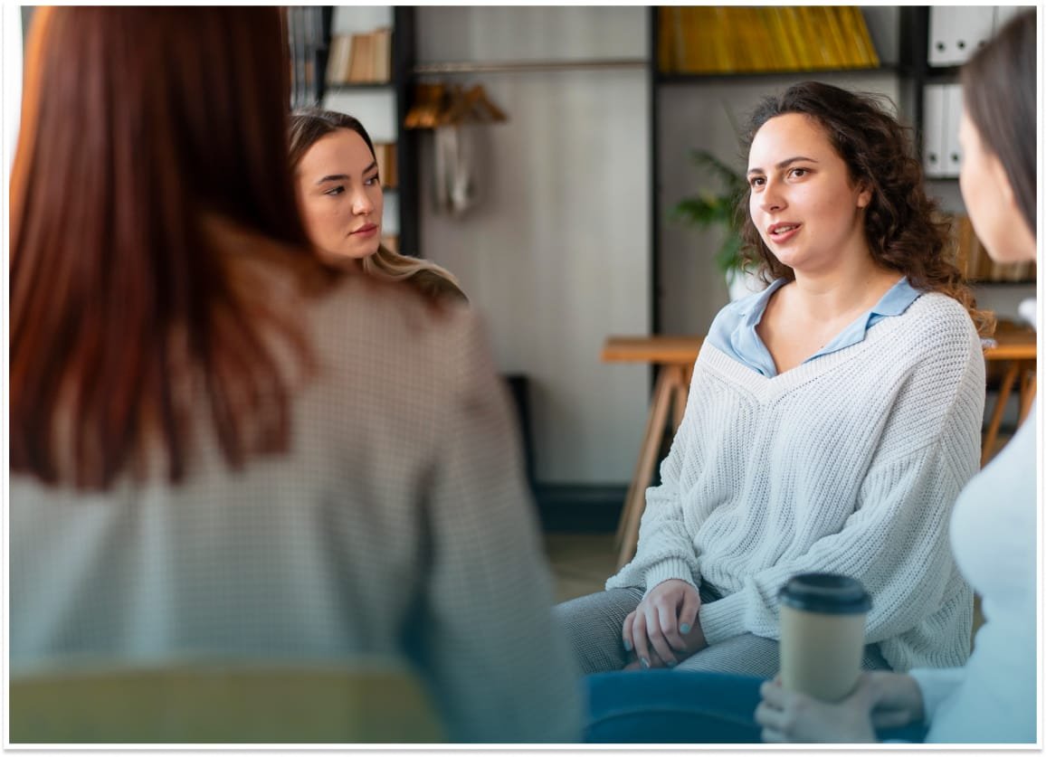 Supportive therapy session for women with eating disorders, highlighting recovery support.