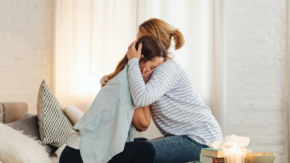 Is Crying Every Day a Sign of Depression a woman cries as she considers the fact she might be depressed.