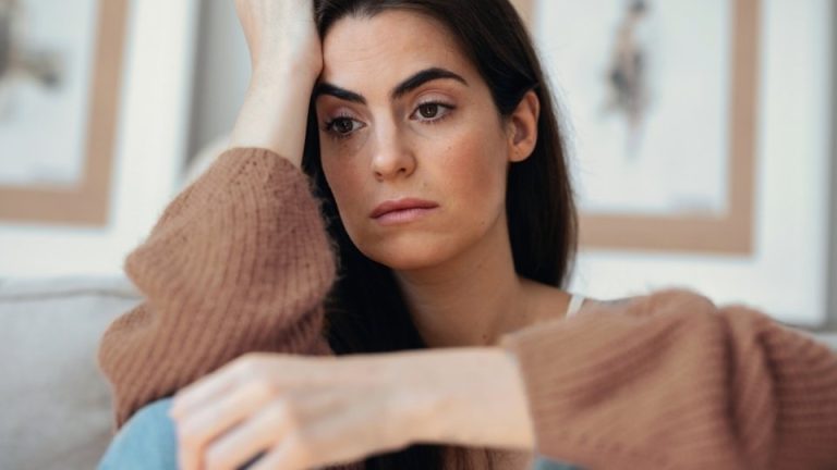 What Causes PTSD in Women hero image of a woman processing trauma.