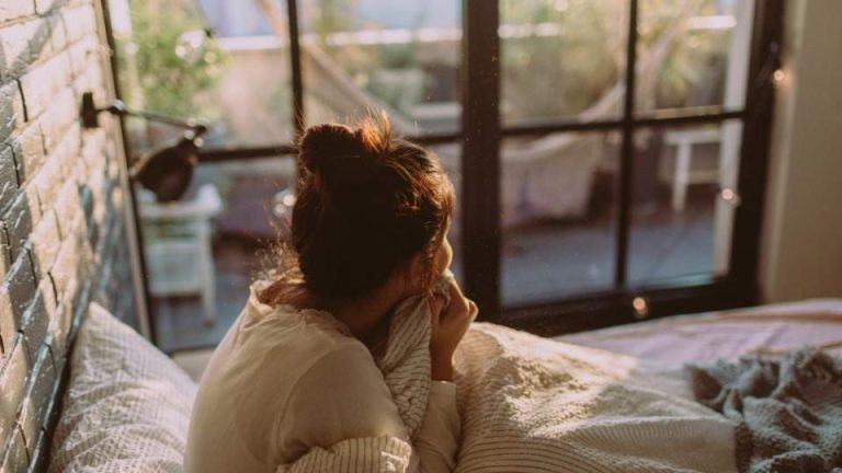 Why Is Depression Worse in the Morning hero image of a woman waking up.